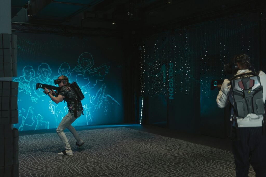 Two men engage in an action-packed virtual reality shooting game indoors.